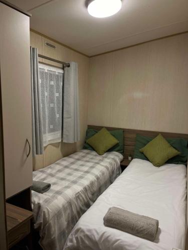 a room with two beds and a window at Woodland Retreat Entire Holiday Home in Hastings in Hastings