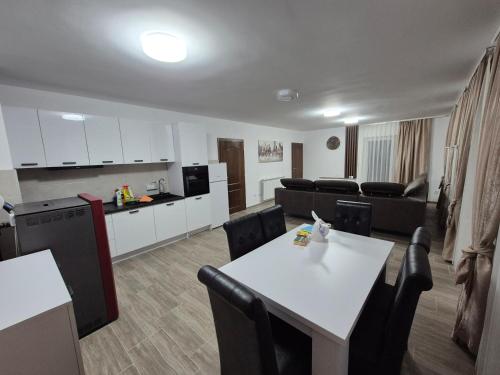 a kitchen and a living room with a table and chairs at Bjance Lux Prijepolje in Prijepolje