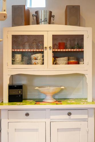 a white cabinet with a bowl inside of it at Gîte du Marais Deauville in Touques