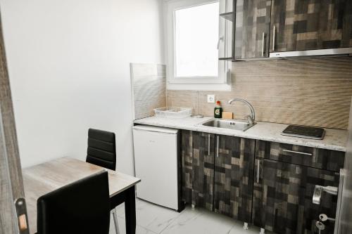 a kitchen with a sink and a dishwasher at Villa Sonja in Neoi Epivates