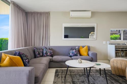 a living room with a couch and a table at 56 Zimbali Wedge in Ballito