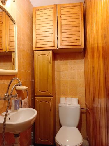 a small bathroom with a toilet and a sink at U Rafcia in Warsaw