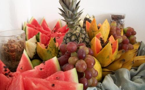 a pile of fruit sitting on top of a table at Hotel Minas Brasil in Montes Claros