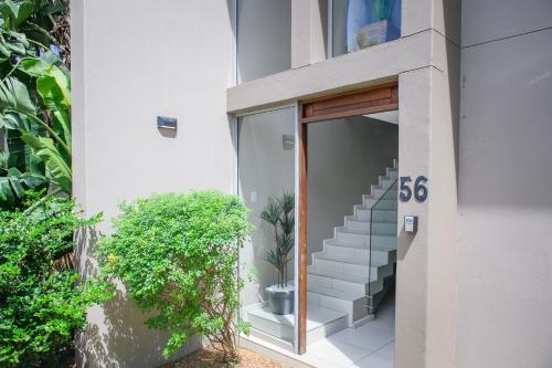 a building with a staircase with a sign that reads at 56 Zimbali Wedge in Ballito