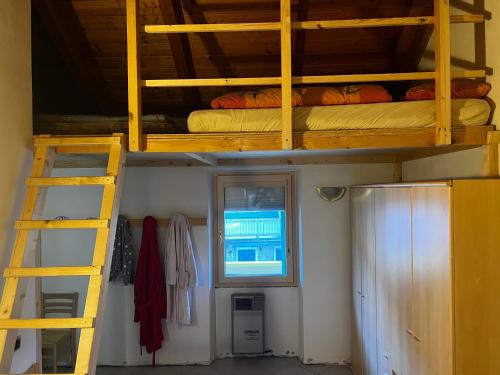 a room with two bunk beds and a ladder at SISSI MENDEL Residence in Ronzone