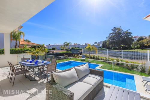 a view of the pool from the patio of a villa at Modern 5BR Villa-Private Pool-Walk to Beach & Oura-10 Guests by Misha's Place in Albufeira