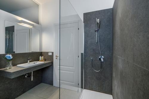 a bathroom with a shower and a sink at Ortigia Amazing Apartment in Siracusa