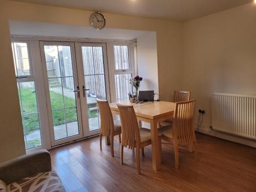 a dining room with a wooden table and chairs at Double Room Ensuite in Dartford