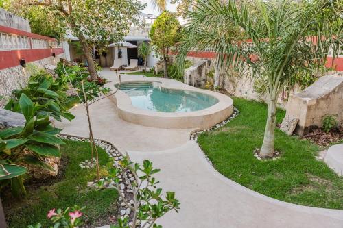 a swimming pool in a yard with trees and plants at La Casa Mosaica in Campeche