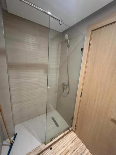 a shower with a glass door in a bathroom at Studio proche clinique akdital ain sebaa in Casablanca