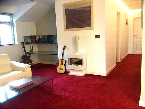 a living room with a guitar and a fireplace at Lanteague Cornwall with stunning Sea Views in Gillan