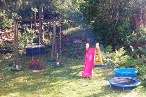 a group of childrens playground equipment in a yard at Woody in Brösarp