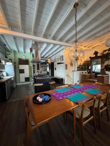 a kitchen and dining room with a wooden table and a dining room at ART LOFT Luxury Apartment Artist's Home in Windsor