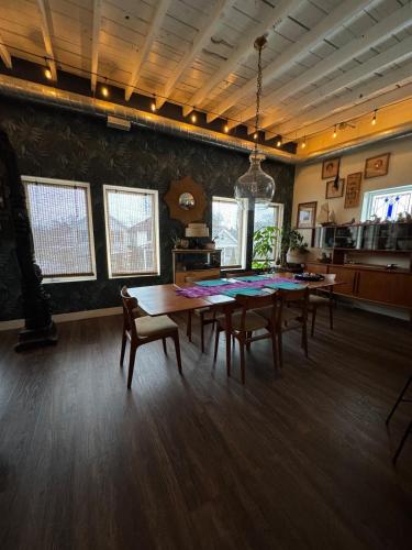 a dining room with a wooden table and chairs at ART LOFT Luxury Apartment Artist's Home in Windsor