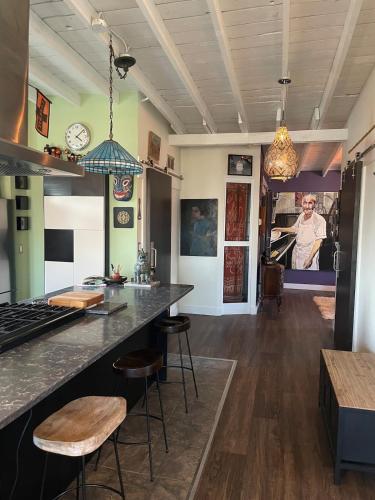 a kitchen with a counter and stools in a room at ART LOFT Luxury Apartment Artist's Home in Windsor