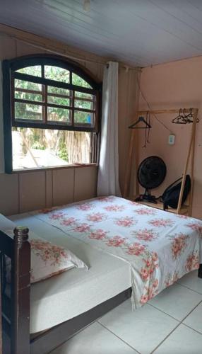 a bed in a room with a window at Pousada e Camping Rhaiana in Ilha do Mel