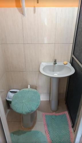 a small bathroom with a sink and a toilet at Pousada e Camping Rhaiana in Ilha do Mel