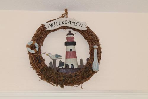 une couronne avec un phare sur un mur dans l'établissement Ferienhaus Pia, à Dorum Neufeld