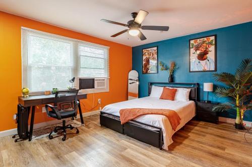 a bedroom with a bed and a desk with a computer at Comfortable 2 Bedroom Near Downtown Atl Sleeps 4 Free Parking in Atlanta