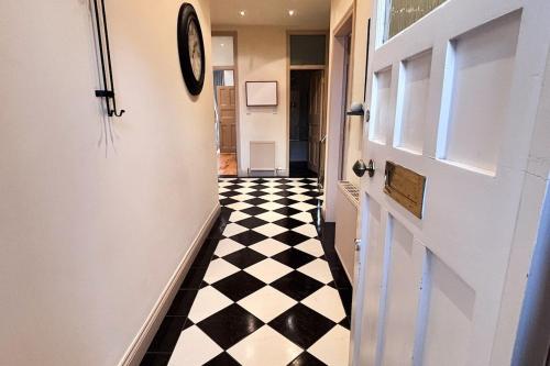a hallway with a black and white checkered floor at Glasgow City - Large Stylish 2 Bed Flat in Unique Ibrox Location Walking Distance to Subway and Free On-Street Parking in Glasgow