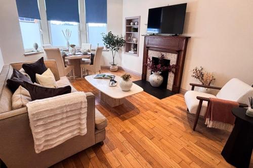 a living room with a couch and a table at Glasgow City - Large Stylish 2 Bed Flat in Unique Ibrox Location Walking Distance to Subway and Free On-Street Parking in Glasgow