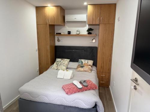 a bed in a small room with a dog laying on it at Francisca River House in Vila Nova de Gaia