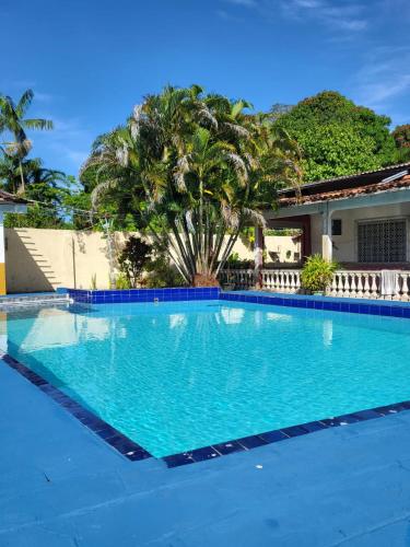 a swimming pool in front of a house at Casa de praia in Belém