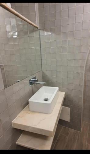 a bathroom with a white sink and a mirror at Casinha do Pão Bolorento in Évora