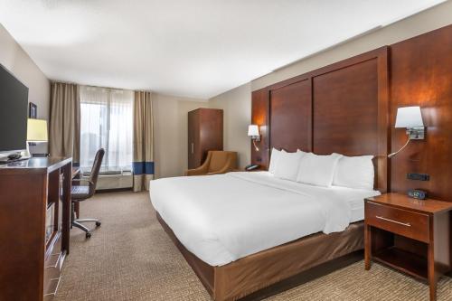 a hotel room with a large bed and a desk at Comfort Inn & Suites Conway in Conway