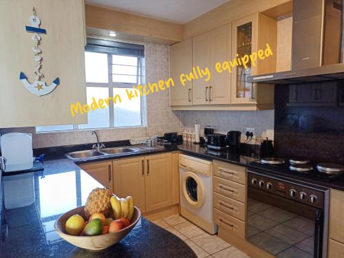 a kitchen with a bowl of fruit on a counter at Driftsands 23 in Doonside