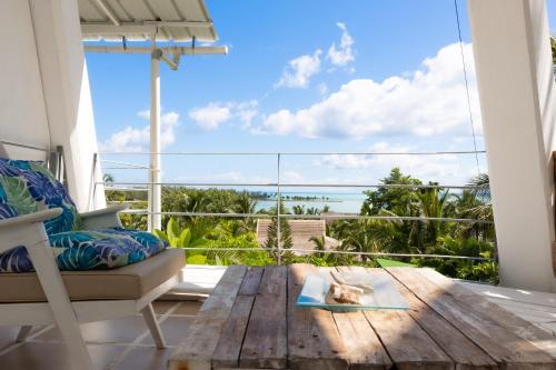 a living room with a table and a view of the ocean at Residence Ma Vie Là Ltee in Le Morne