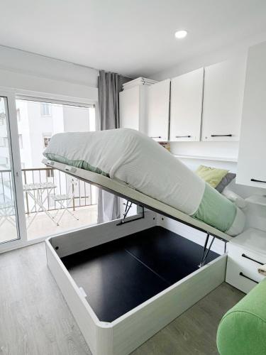 a bunk bed in a room with a window at Estudio primer line playa Fuengirola 3 people in Fuengirola