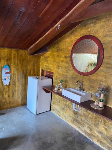 a kitchen with a white refrigerator and a sink at KiteHouseArpoeiras in Acaraú