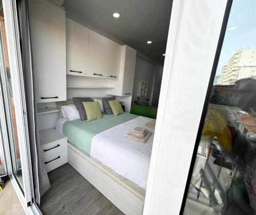 a small bedroom with a bed in a room at Estudio primer line playa Fuengirola 3 people in Fuengirola
