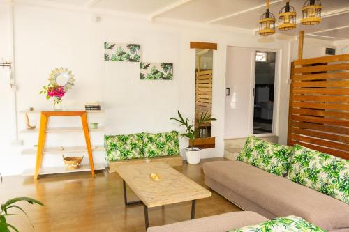 a living room with a couch and a table at Residence Ma Vie Là Ltee in Le Morne