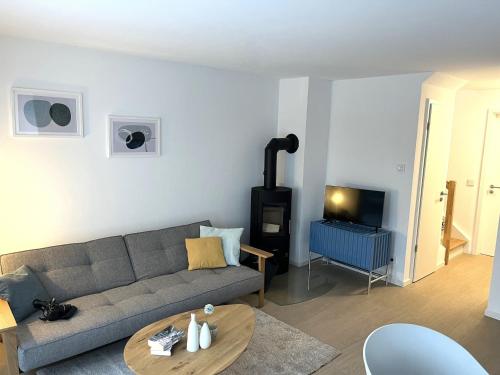 - un salon avec un canapé et un poêle à bois dans l'établissement Ferienhaus Michel, à Butjadingen