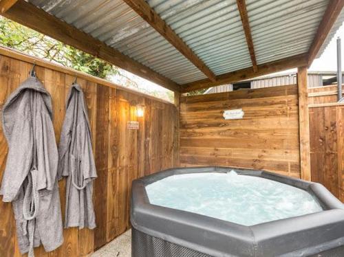 a jacuzzi tub in a wooden wall at Cozy Haven Glamping Pod 1With Hot Tub & Cold Shower in Naas