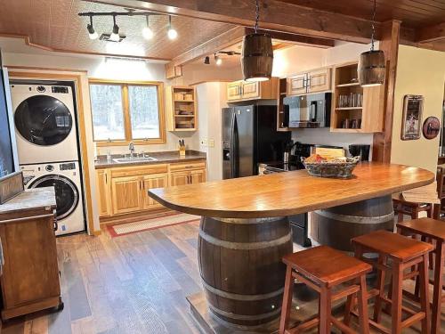 a kitchen with a large wooden table in a room at The Game Cabin at Rustic River in Austinburg