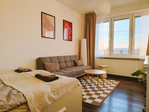 a living room with a bed and a couch at Byt v meste Piešťany in Piešťany