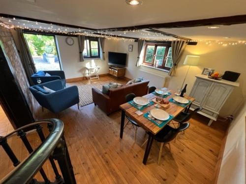 an aerial view of a living room with a table at The Quintessential Dorset Cottage in Lytchett Matravers