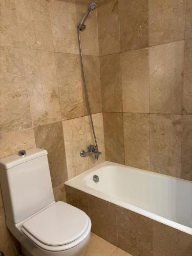 a bathroom with a toilet and a bath tub at Charming 3 Bedroom apartment with sea view in the heart of Sotogrande in Sotogrande