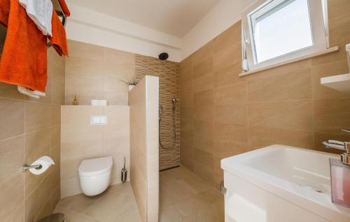 a bathroom with a toilet and a sink at Amazing Home In Kastel Stafilic in Kastel Stafilic