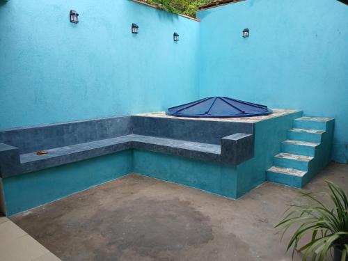 a blue wall with stairs and an umbrella on it at Casa Moriá in Lençóis