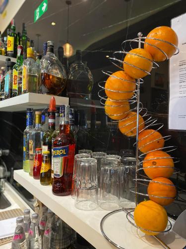 a display case with bottles of alcohol and bunasteryasteryasteryasteryasteryasteryastery at Hotel Stradivari in Milan