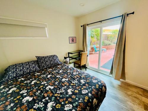 a bedroom with a bed and a sliding glass door at Private Room0 Own Bath Own Entry Shared Kitchen Walk to UCSD in San Diego