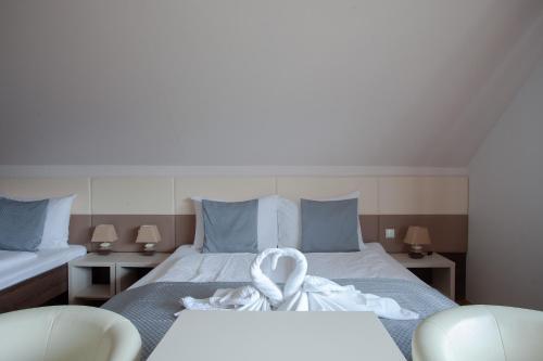 a bedroom with a bed with a towel on it at Pension Bled in Bled