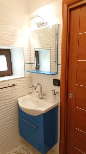 a bathroom with a sink and a mirror at La Casetta di Mimma in Viggiano