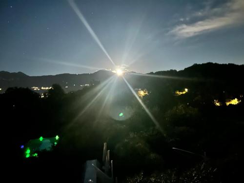 a view of the sun setting over a city at Amata Valgre Affittacamere, comfort e pulizia eccezionali!! in Olginate