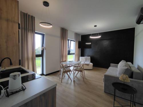 a living room with a couch and a table at Horizon Park Boszkowo in Boszkowo-Letnisko