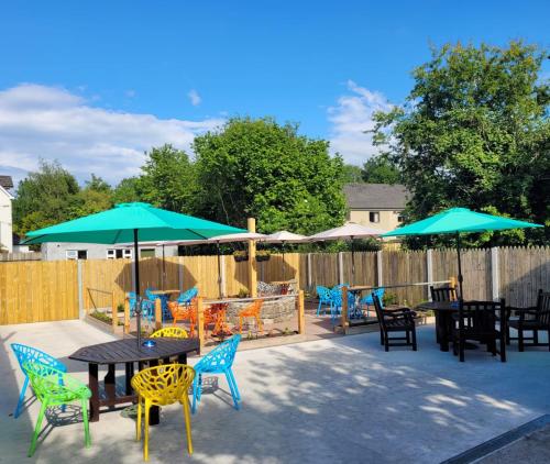 a patio with tables and chairs and umbrellas at Leanna's Lodge, Keshcarrigan in Leitrim